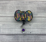 Sally Inspired Bow Badge Reel